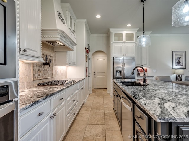 2915 E Rockford Pl, Broken Arrow, OK 74014 - kitchen featuring a sink, custom exhaust hood, ornamental molding, stone tile flooring, and backsplash