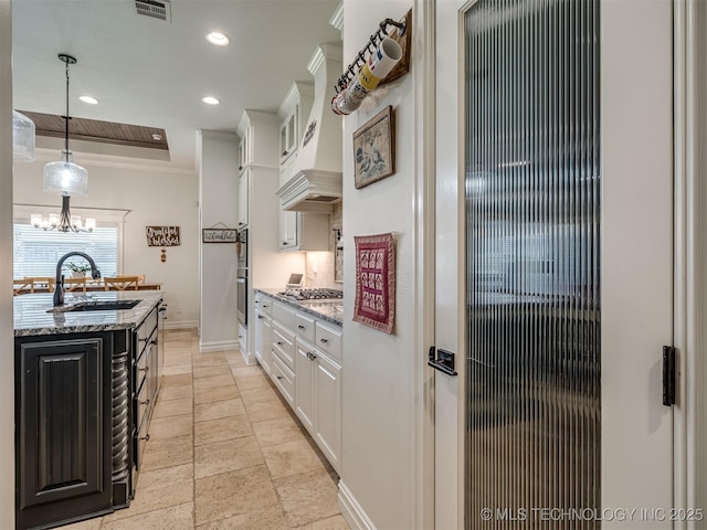 2915 E Rockford Pl, Broken Arrow, OK 74014 - kitchen featuring a sink, premium range hood, baseboards, white cabinets, and ornamental molding