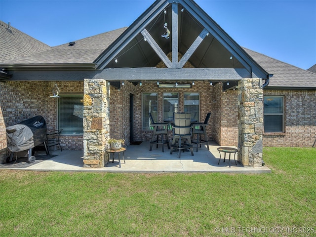 2915 E Rockford Pl, Broken Arrow, OK 74014 - back of house with brick siding, a patio area, a lawn, and roof with shingles