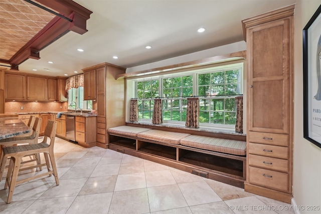 3898 E 72nd St, Tulsa, OK 74136 - kitchen with stainless steel dishwasher, light tile patterned floors, backsplash, recessed lighting, and stone counters