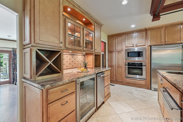 3898 E 72nd St, Tulsa, OK 74136 - kitchen with stainless steel appliances, wine cooler, tasteful backsplash, light stone countertops, and recessed lighting