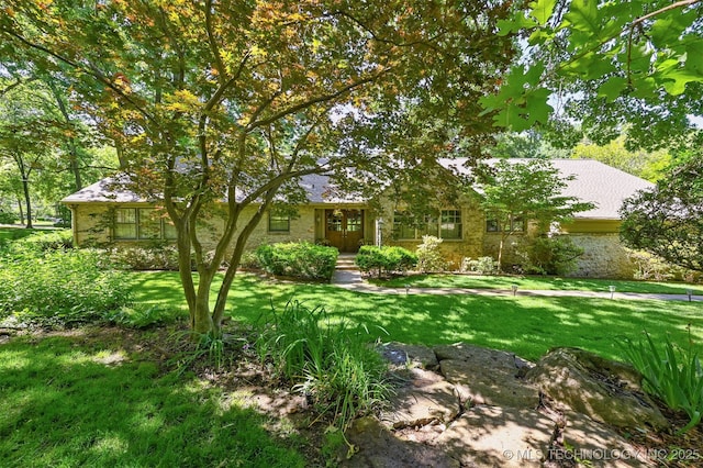 3898 E 72nd St, Tulsa, OK 74136 - view of property hidden behind natural elements with a front yard and stone siding
