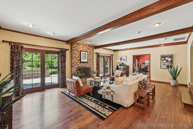 3898 E 72nd St, Tulsa, OK 74136 - living room featuring wood-type flooring, beam ceiling, a brick fireplace, baseboards, and crown molding