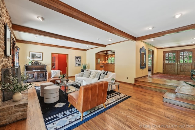 3898 E 72nd St, Tulsa, OK 74136 - living area featuring light wood-style floors, arched walkways, beamed ceiling, crown molding, and baseboards
