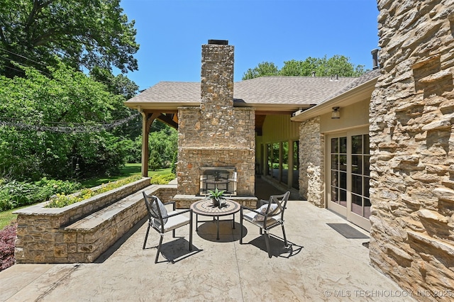 3898 E 72nd St, Tulsa, OK 74136 - view of patio with an outdoor stone fireplace