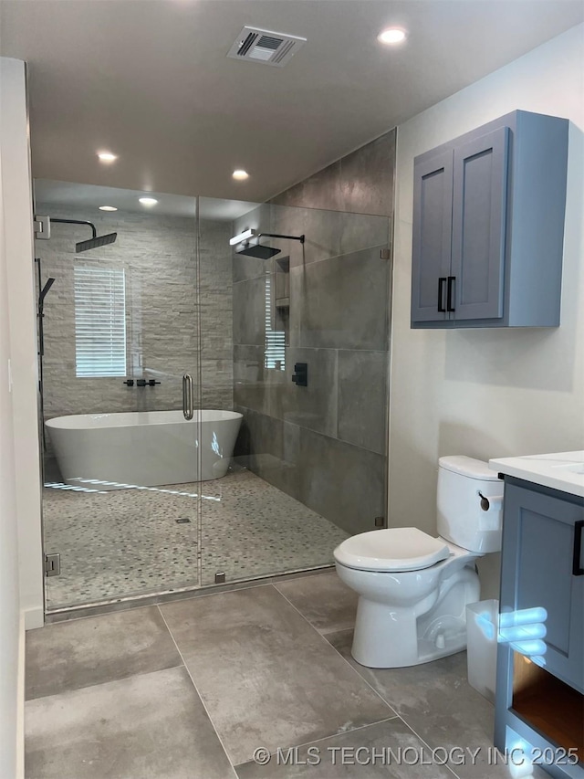 56648 Bloomer Rd, Afton, OK 74331 - bathroom featuring toilet, vanity, a shower stall, recessed lighting, and a freestanding tub