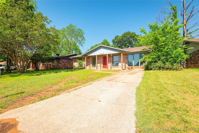 2207 Hillcrest Ct, Durant, OK 74701 - view of front of property with concrete driveway, brick siding, and a front lawn