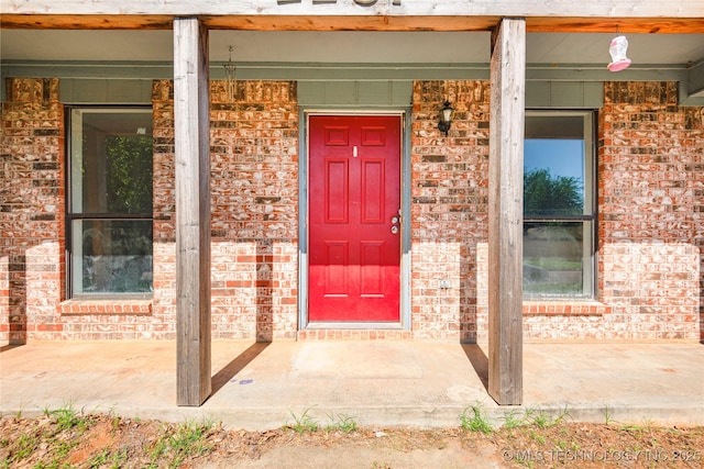 2207 Hillcrest Ct, Durant, OK 74701 - doorway to property featuring brick siding and covered porch