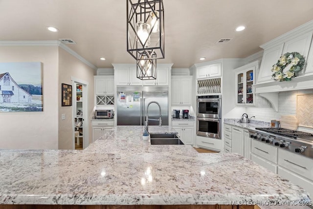 589 Three Mile Rd, Durant, OK 74701 - kitchen with stainless steel appliances, a sink, tasteful backsplash, recessed lighting, and white cabinets
