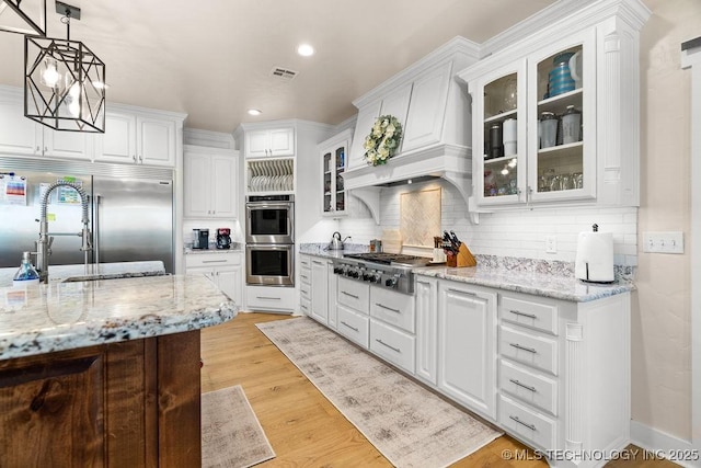 589 Three Mile Rd, Durant, OK 74701 - kitchen featuring appliances with stainless steel finishes, a sink, tasteful backsplash, white cabinets, and recessed lighting