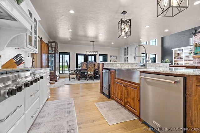589 Three Mile Rd, Durant, OK 74701 - kitchen with dishwasher, a sink, brown cabinets, light wood finished floors, and recessed lighting
