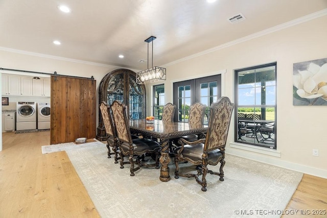589 Three Mile Rd, Durant, OK 74701 - dining area featuring washing machine and dryer, light wood finished floors, ornamental molding, recessed lighting, and a barn door
