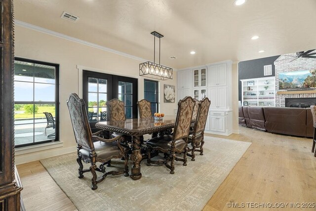 589 Three Mile Rd, Durant, OK 74701 - dining area with ornamental molding, light wood finished floors, recessed lighting, baseboards, and a fireplace