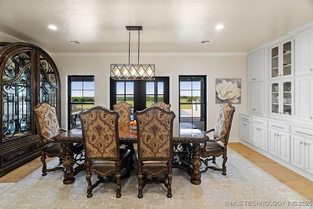 589 Three Mile Rd, Durant, OK 74701 - dining space with light wood-style flooring, ornamental molding, recessed lighting, french doors, and baseboards