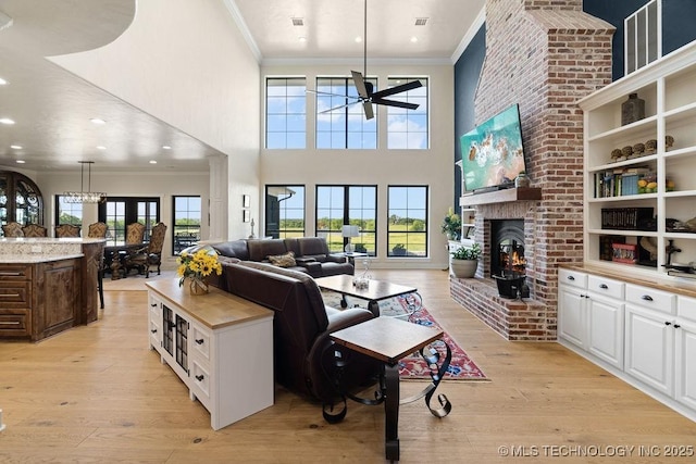 589 Three Mile Rd, Durant, OK 74701 - living area featuring crown molding, a ceiling fan, light wood-type flooring, a high ceiling, and recessed lighting