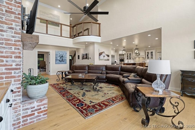 589 Three Mile Rd, Durant, OK 74701 - living area featuring ceiling fan, light wood finished floors, a towering ceiling, ornamental molding, and recessed lighting