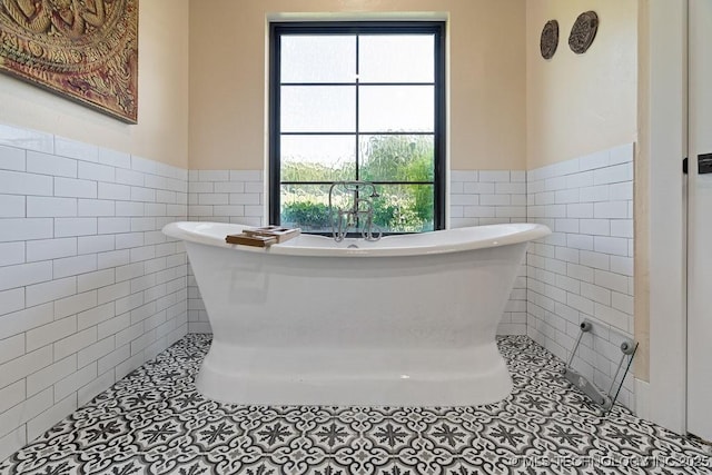 589 Three Mile Rd, Durant, OK 74701 - bathroom with tile walls, wainscoting, tile patterned floors, and a soaking tub