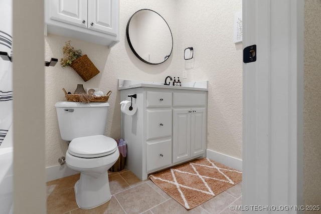 589 Three Mile Rd, Durant, OK 74701 - bathroom featuring vanity, toilet, a textured wall, tile patterned floors, and baseboards
