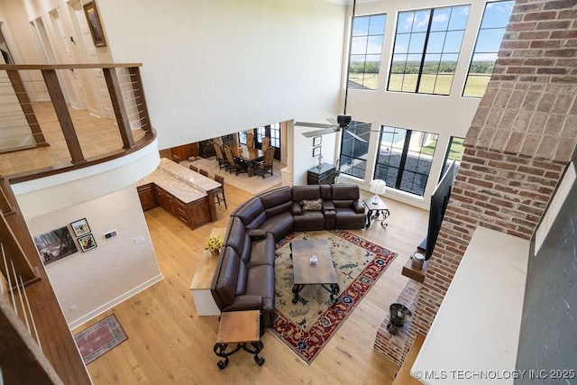 589 Three Mile Rd, Durant, OK 74701 - living area with wood finished floors, a high ceiling, and a ceiling fan