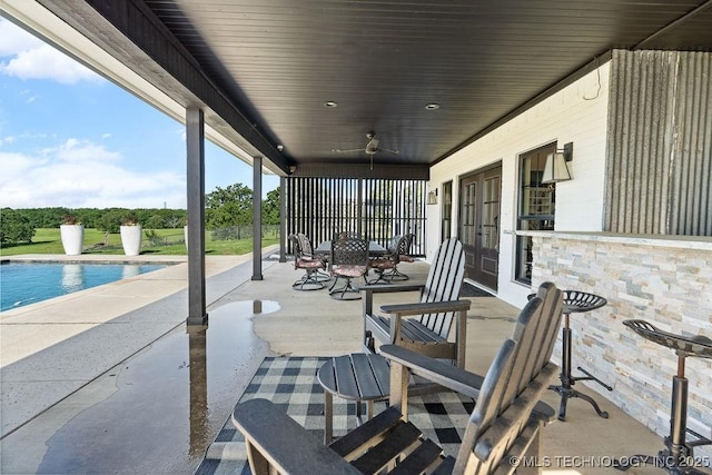 589 Three Mile Rd, Durant, OK 74701 - view of patio / terrace featuring french doors, a ceiling fan, an outdoor pool, and outdoor dining area