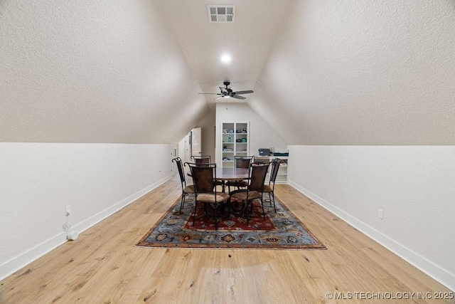 589 Three Mile Rd, Durant, OK 74701 - dining area featuring baseboards, lofted ceiling, a textured ceiling, wood finished floors, and ceiling fan