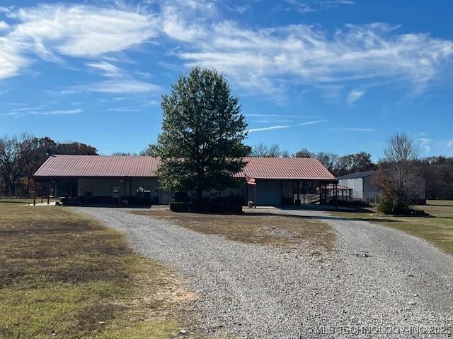 376 Lotoroc Ranch Rd, Barnsdall, OK 74002 - ranch-style home with gravel driveway and metal roof