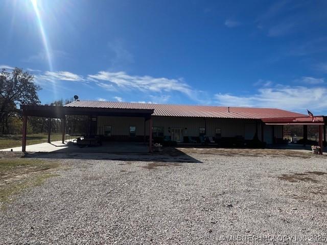 376 Lotoroc Ranch Rd, Barnsdall, OK 74002 - back of property featuring metal roof and a carport