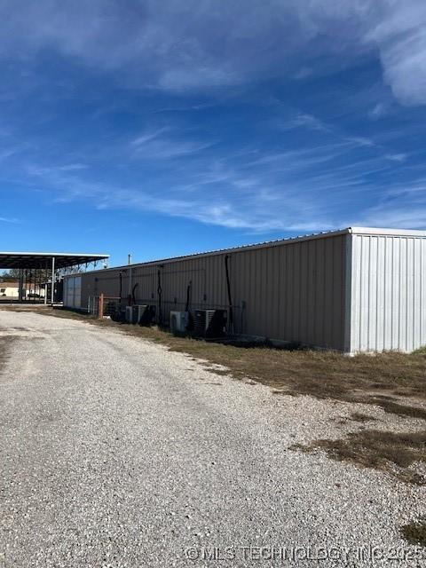376 Lotoroc Ranch Rd, Barnsdall, OK 74002 - view of pole building featuring driveway, a carport, and central AC unit