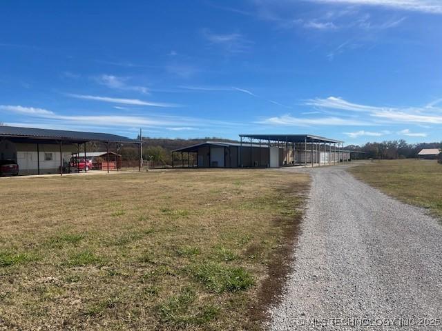 376 Lotoroc Ranch Rd, Barnsdall, OK 74002 - view of front of house featuring a detached carport, driveway, and a front lawn