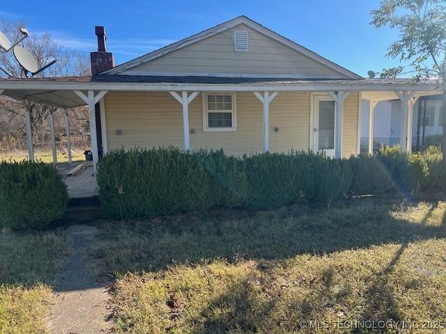 376 Lotoroc Ranch Rd, Barnsdall, OK 74002 - view of front of house with a chimney and a porch