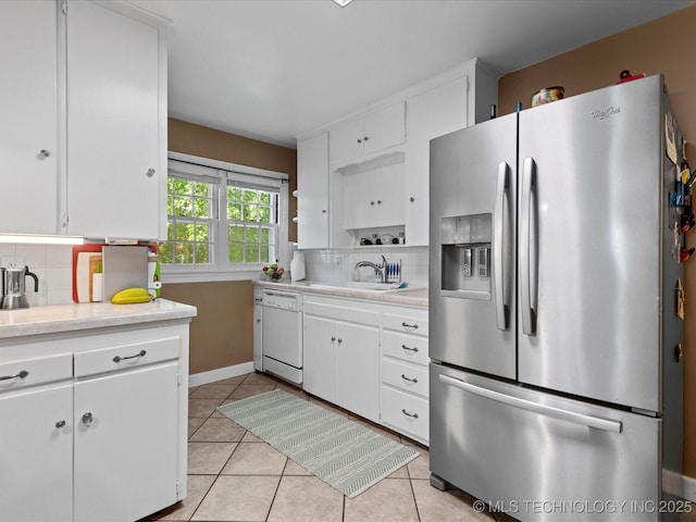 1626 S Dewey Ave, Bartlesville, OK 74003 - kitchen featuring stainless steel fridge, dishwasher, decorative backsplash, and light countertops