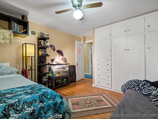 1626 S Dewey Ave, Bartlesville, OK 74003 - bedroom featuring light wood-style flooring, a closet, and ceiling fan