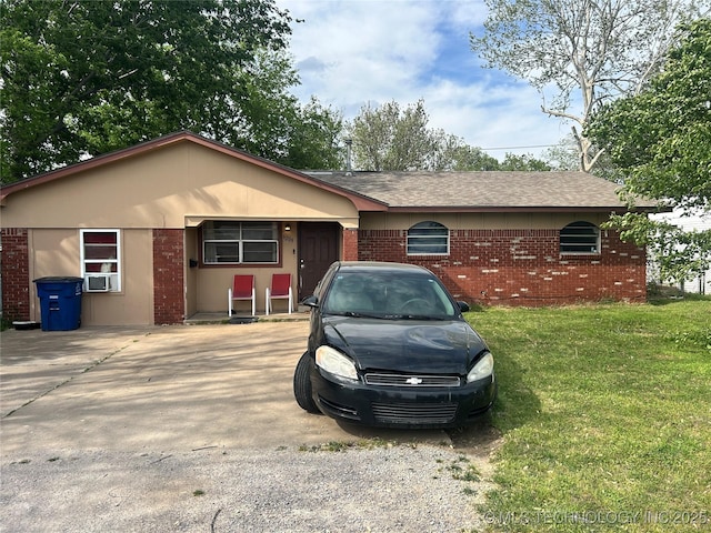 6209 E Young Pl, Tulsa, OK 74115 - ranch-style home featuring brick siding, a front yard, and roof with shingles