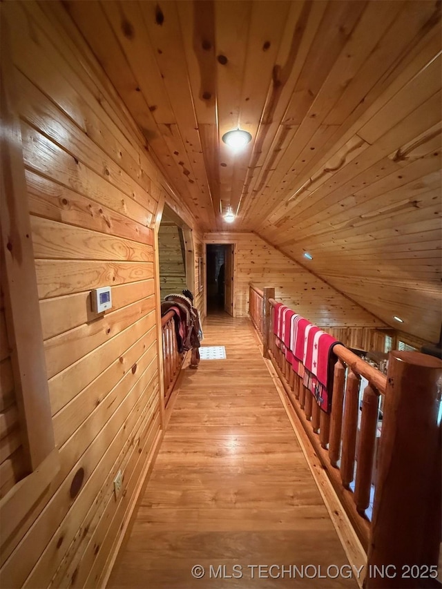 7905 Hornbeam Rd, Henryetta, OK 74437 - hallway with wood walls, wooden ceiling, light wood-style floors, and vaulted ceiling