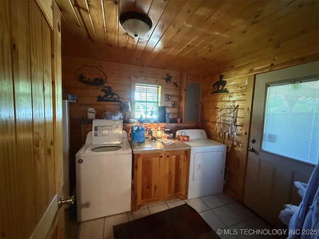 7905 Hornbeam Rd, Henryetta, OK 74437 - laundry area with wooden ceiling, cabinet space, light tile patterned floors, wooden walls, and independent washer and dryer