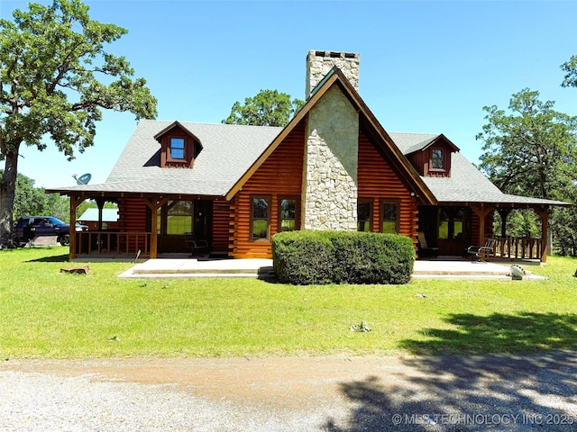 7905 Hornbeam Rd, Henryetta, OK 74437 - rear view of property with a porch, log siding, a yard, and a chimney
