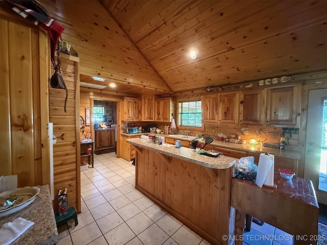 7905 Hornbeam Rd, Henryetta, OK 74437 - kitchen with lofted ceiling, wooden ceiling, a sink, light tile patterned floors, and a kitchen island