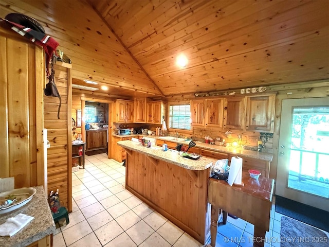 7905 Hornbeam Rd, Henryetta, OK 74437 - kitchen with vaulted ceiling, wood ceiling, light tile patterned floors, a kitchen island, and light stone countertops