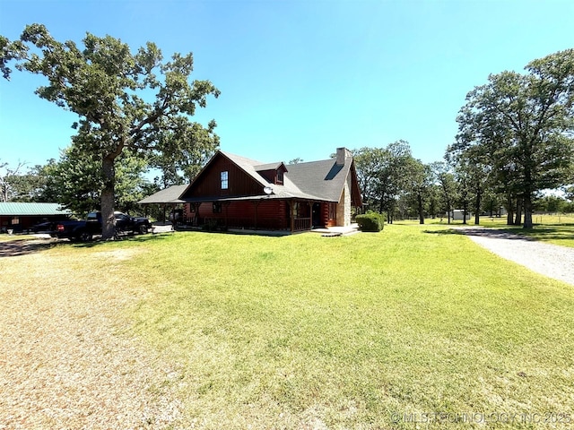 7905 Hornbeam Rd, Henryetta, OK 74437 - view of property exterior featuring a chimney and a lawn