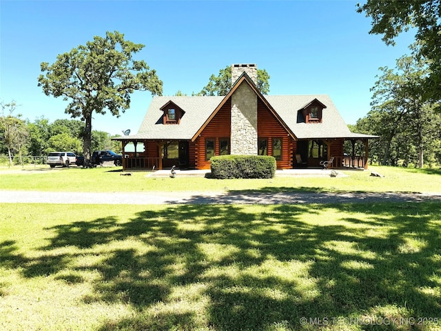 7905 Hornbeam Rd, Henryetta, OK 74437 - log home with covered porch, a front yard, and a chimney