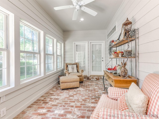609 E Pensacola St, Broken Arrow, OK 74011 - sunroom featuring healthy amount of natural light, brick flooring, and wooden walls