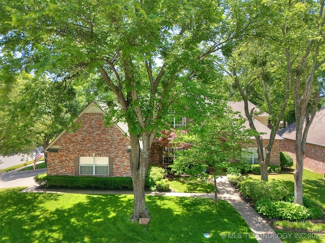 609 E Pensacola St, Broken Arrow, OK 74011 - obstructed view of property featuring a front yard and brick siding