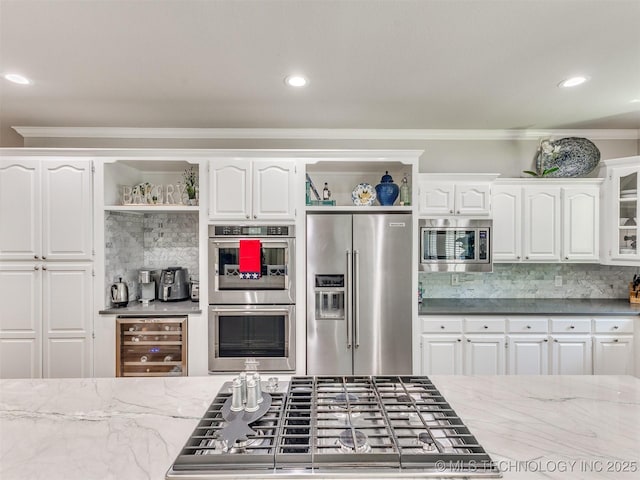 609 E Pensacola St, Broken Arrow, OK 74011 - kitchen with appliances with stainless steel finishes, open shelves, beverage cooler, decorative backsplash, and crown molding