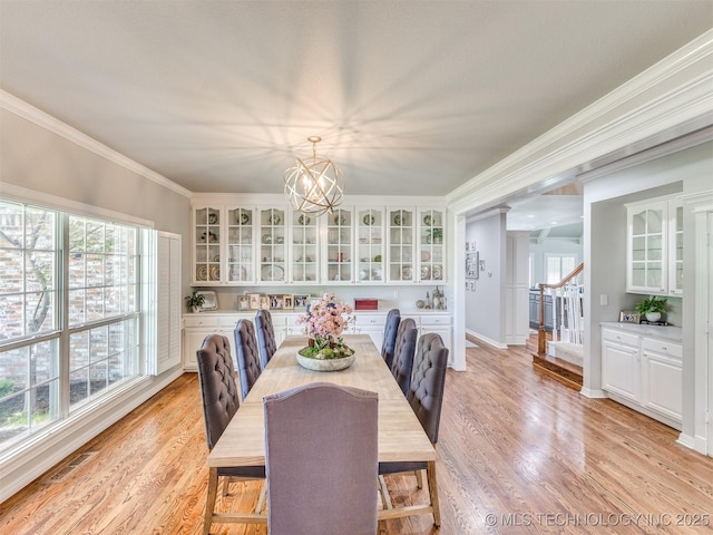 609 E Pensacola St, Broken Arrow, OK 74011 - dining space featuring ornamental molding, stairway, light wood-style flooring, and a chandelier