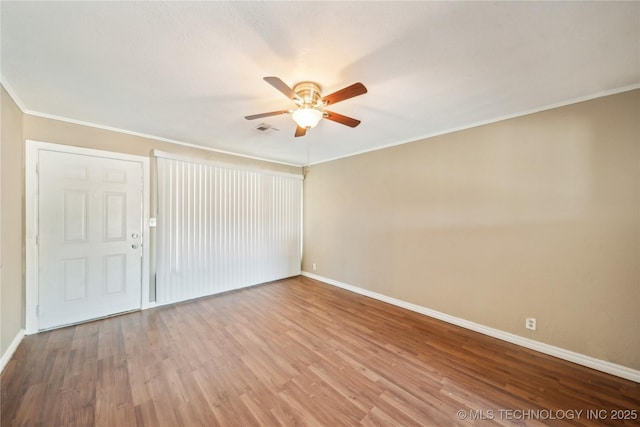 8009 E 2nd St, Tulsa, OK 74112 - unfurnished room with ceiling fan, baseboards, wood finished floors, and crown molding