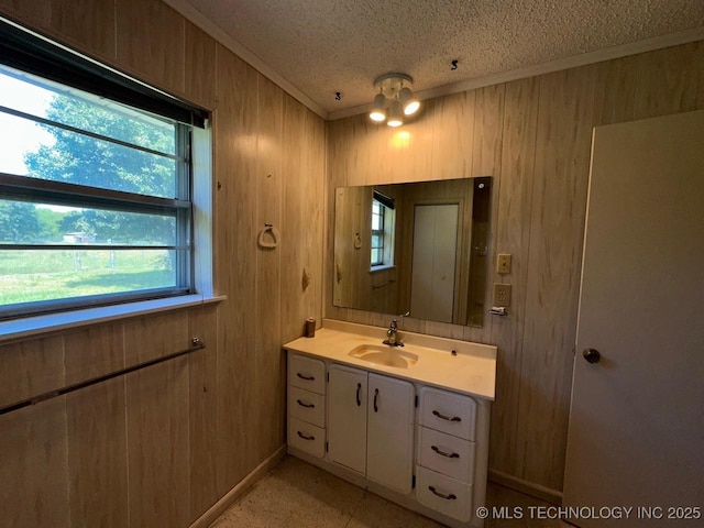 109948 S 4155th Rd, Checotah, OK 74426 - bathroom featuring ornamental molding, wood walls, a textured ceiling, vanity, and baseboards