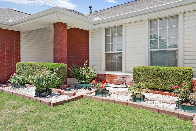 12013 E 27th St, Tulsa, OK 74129 - entrance to property with brick siding, a shingled roof, and a yard