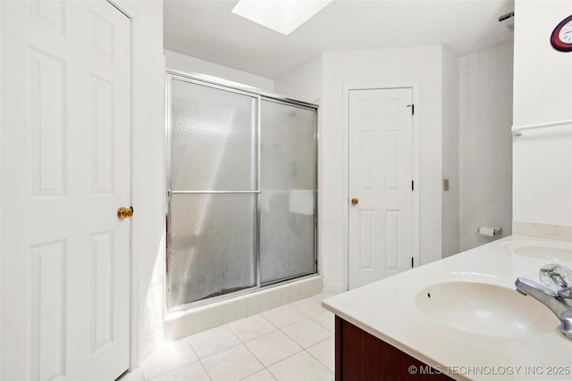 12013 E 27th St, Tulsa, OK 74129 - full bath featuring a shower stall, double vanity, and tile patterned floors