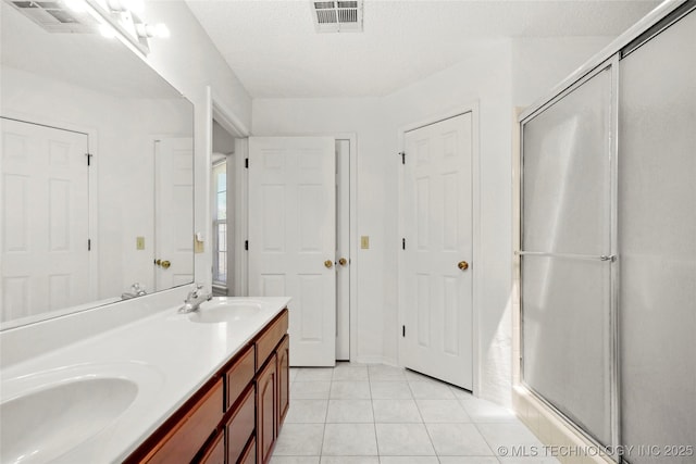12013 E 27th St, Tulsa, OK 74129 - full bathroom with double vanity, a stall shower, and tile patterned floors