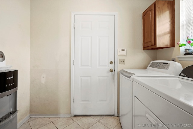 12013 E 27th St, Tulsa, OK 74129 - washroom featuring washer and dryer, cabinet space, baseboards, and light tile patterned flooring
